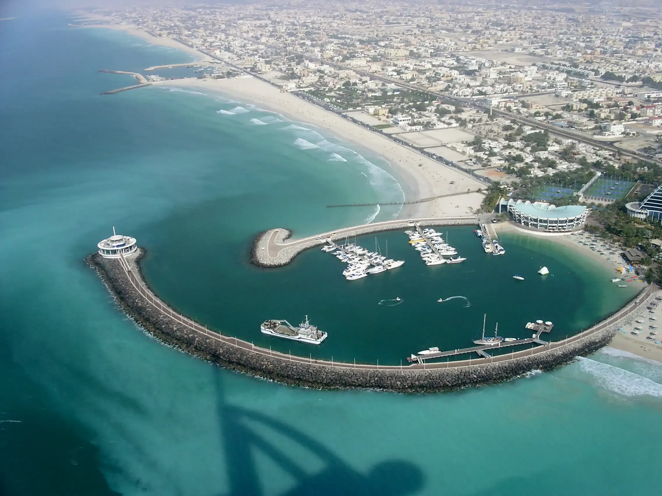 Aerial view of a Dubai beach marina and breakwater