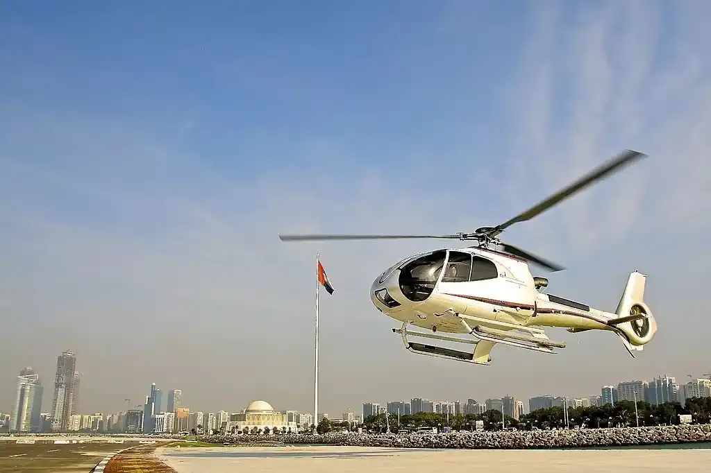Helicopter lifting off beside the corniche skyline