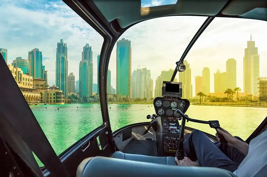 Helicopter Ride and Tours Dubai blue and gold helicopter on the apron
